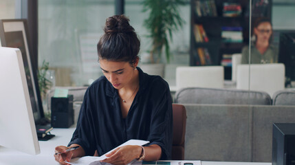 Creative, business woman and reading paperwork files, list and information in startup office....