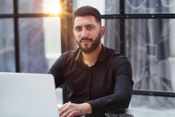 Middle-aged man working on laptop in office