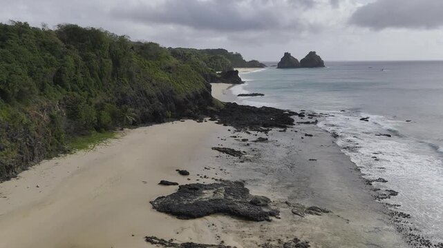 Drone flies low along Praia do Boldr&oacute; to Praia do Americano ending up at Praia do Bode on overcast day in Fernando de Noronha, Pernambuco, Brazil