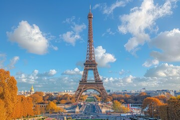 Daytime view of the Eiffel Tower against a bright clear sky in autumn.