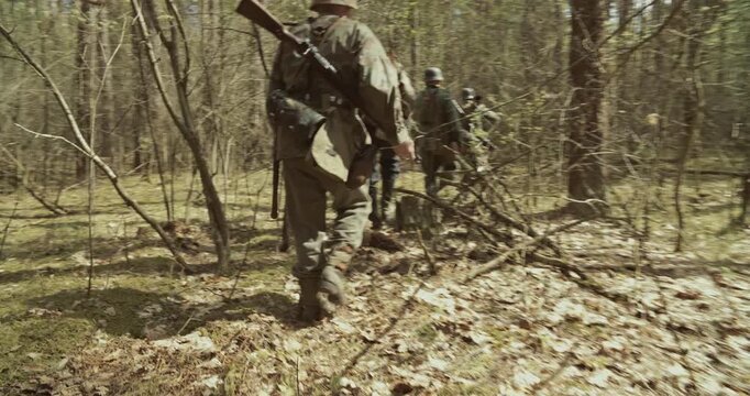 Following For Group Of Soldiers With Carabines Mauser 98k, Panzerschreck In Forest. Reenactors Dressed As German Infantry Soldiers Marching By Forest Autumn Season. Wermacht Military Uniform