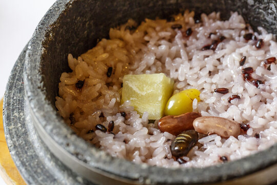 Close-up of Nutritious Hot Stone Pot Rice with black rice, ginkgo seed, bean and sweet potato on stone pot at restaurant, South Korea

