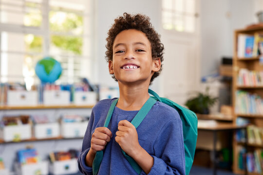 Proud multiethnic schoolboy smiling at elementary school
