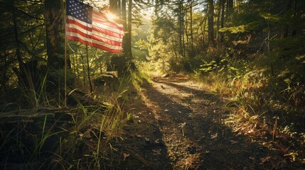 The american flag flutters in the wind along a forest hiking trail as the sun sets