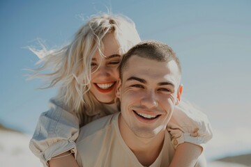 Obraz premium Woman, multiracial couple, and piggyback bring love, happiness, and suntime pleasure. A happy couple on vacation in the sun with a blue sky