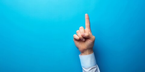 Isolated white finger pointing upwards on a bright blue background, symbolizing direction, guidance, and decision-making, conveying a sense of confidence and authority.
