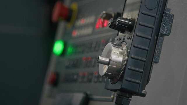 No people side shot of switches on small panel of industrial computer-assisted controller in manufacturing factory