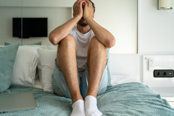 Man covering face with hands in distress. Emotional stress, anxiety, mental health, and personal...