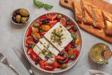fresh feta cheese salad with organic tomatoes with olives and basil, olive oil and aromatic herbs, Healthy lunch or dinner with 