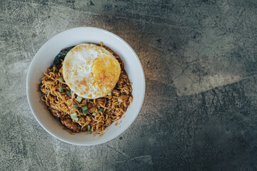 Mie Bangladesh with boiled egg and some vegetables made from instant noodles originate from Medan or Aceh. Typical Southeast Asian food. Flat lay or top view angle with the object on the left.