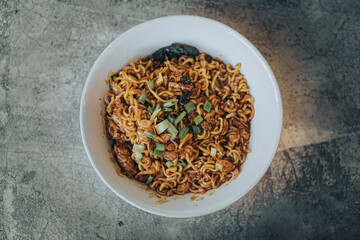 Mie Bangladesh some vegetables made from instant noodles originate from Medan or Aceh. Typical Southeast Asian food. Flat lay or top view angle with object on the center.