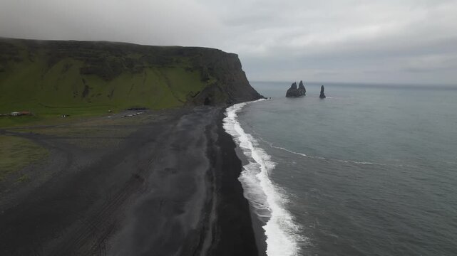 drone aerial view of ocean waves in iceland on a black beach vik iceland