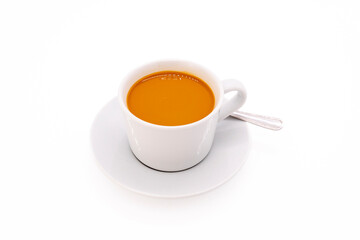 Creamy coffee on a white porcelain cup, isolated on white background with copy space.