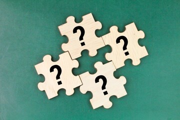 wooden puzzle with a question mark symbol. Concept of question, FAQ, Q and A, confusion and...