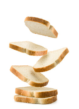 Slices of white bread falling on white background.
