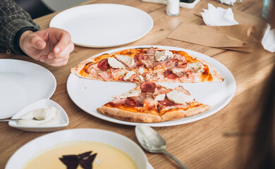Cheese cream soup and pizza in the home kitchen, homemade food for family lunch.