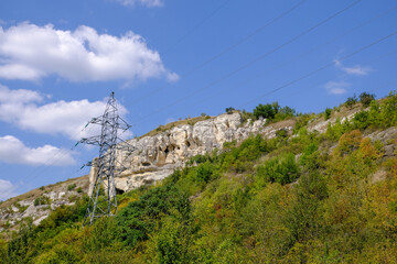 High-voltage electric pole against the backdrop of majestic mountains in America