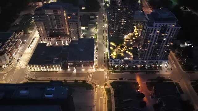 Drone footage of the illuminated buildings and streets at dusk in Waterloo, Ontario, Canada