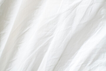 Obraz premium Abstract White Bedding Sheets or White wrinkled fabric background texture and Texture with copy-space :Creased or wrinkled white fabric,Soft focus