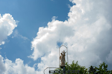 statue of the Virgin in nature under the rays of the sun