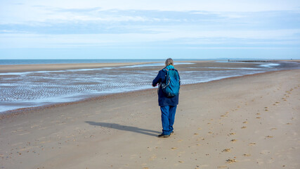 Lone woman on the beach in Zeeland, Netherlands
