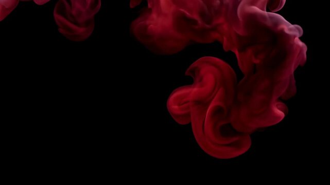 Swirling Red Smoke Forming Abstract Patterns in Darkness.