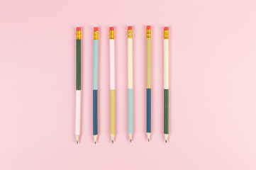 Top view of colorful pencils on pink background. School, office, art wallpaper. Flat lay, copy space.