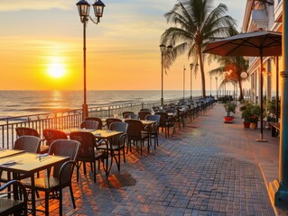 Sunrise view from a beachfront cafe terrace with empty tables, ocean, and palm trees. Peaceful and scenic atmosphere.