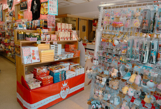 DAZAIFU, JAPAN - May 29, 2024: People waliking along souvenirs  shop and food store in front of Dazaifu Tenmangu shrine entrance.