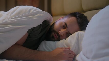 Caucasian man lying on bed trying sleep awake insomnia male guy late night bedroom home sleepless looking contemplation bedtime anxiety difficulty thinking disturbed sleeping problems worried medicine