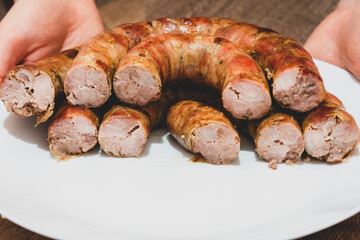 sausage cut, cooked sausage filling. Homemade Pork sausage on the plate.