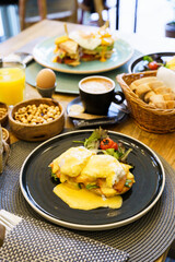 Eggs Benedict with salmon on a wooden table