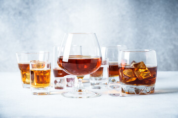 Strong alcohol drink. Cognac, whisky, rum, tequila at light background.