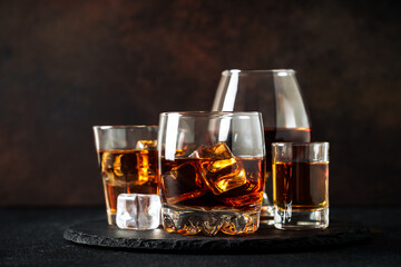 Strong alcohol drink. Whisky, rum, tequila, cognac at dark bar.