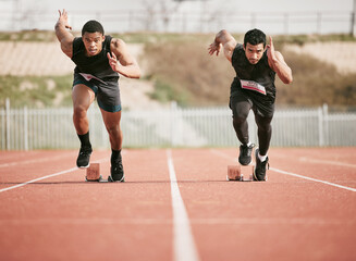 Race, start and men running on track for speed challenge, marathon event and professional sports at arena. Action, go and people at stadium for competition, fitness and fast athlete runner in sprint