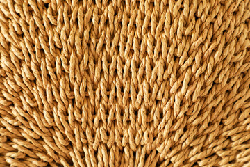 Textured background woven from large natural wheat-colored fibers