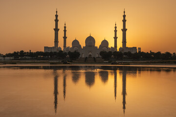 View of Grand Mosque in Abu Dhabi during very nice sunset. Beautifull warm colors on the sky.