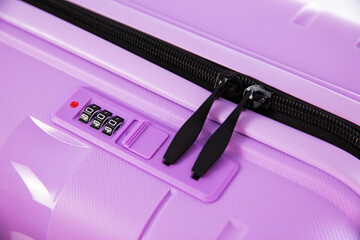Modern padlock on purple suitcase with combination lock, macro