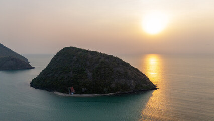 Sunrise golden sky in morning, The golden light reflects beautifully on the sea, mountains background.