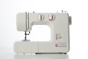 Automatic modern sewing machine with overlock on a white background, isolate. Studio concept. Tailoring services