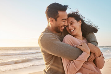 Travel, sunset and couple with hug at beach for affection, relationship or weekend getaway. Love,...