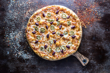 Messicana Pizza topping with jalapeno served in wooden board isolated on dark background top view of italian fastfood