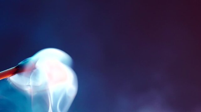 White smoke from an extinguished match on dark background