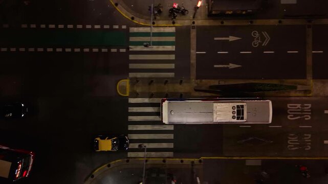 Buses and cars travel along Corrientes Avenue in Buenos Aires, Argentina. Bird's eye view camera follows them