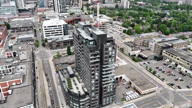 Aerial footage of the urban building "One Victoria Condominiums" in a suburban area