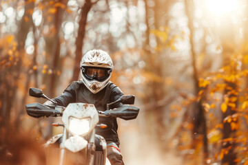 Portrait of biker with a helmet riding motorcycle bike in autumn fall forest woods nature outdoors. Extreme offroad terrain sport adventure, ATV vehicle, wilderness, goggles. Photo