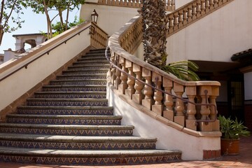 wide formal exterior staircase with decorative balustrade