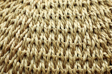 Textured natural background woven from large natural straw-colored fibers