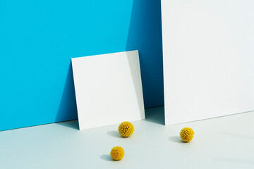 White blank square paper mockup on blue background with billy buttons