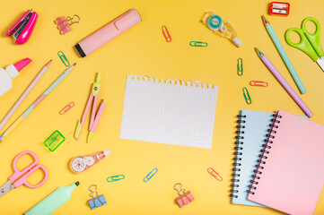 Back to school concept. School stationery on yellow background. Workplace organization.